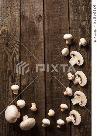 sliced champignon mushrooms on slate and wooden counter top background sliced champignon mushrooms on slate and wooden counter top background 82893134