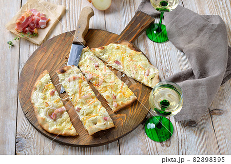 Tarte flambee from Alsace with onions, smoked bacon and munster cheese 82898395