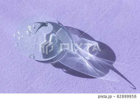 Single blob of transparent glycerin or gel smear smudge swatch on lilac backdrop with shadow. Glossy texture with tiny bubbles. Styling gel lotion, cleanser, shampoo drop Single blob of transparent glycerin or gel smear smudge swatch on lilac backdrop with shadow. Glossy texture with tiny bubbles. Styling gel lotion, cleanser, shampoo drop 82899956