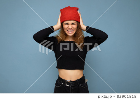Shot of young emotional nice winsome brunet woman wavy-haired with sincere emotions wearing black 82901818