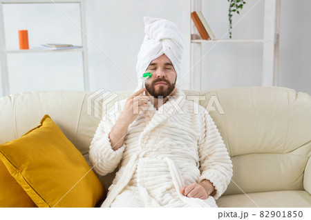 Bearded man with facial massage tool. Male skin care and spa concept. 82901850
