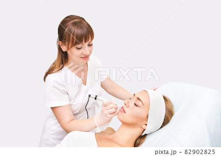 Permanent makeup. Beauty spa procedure. Beauty young woman. Lip tattoo Permanent makeup. Beauty spa procedure. Beauty young woman. Lip tattoo 82902825