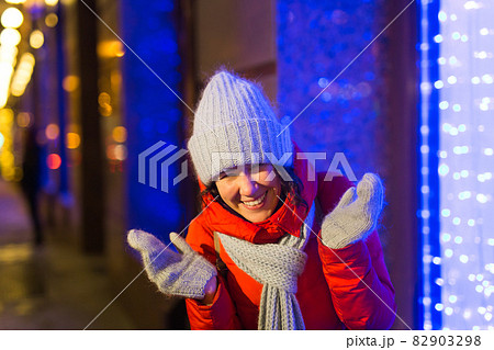 Girl in a night city snowflake Christmas city lights. Christmas and winter holidays concept. 82903298
