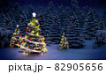 shiny Christmas tree before snow covered forest at night 82905656