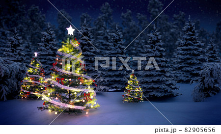 shiny Christmas tree before snow covered forest at night shiny Christmas tree before snow covered forest at night 82905656