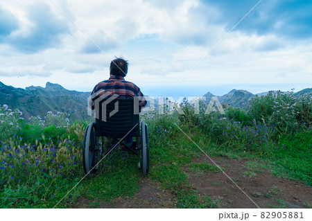 Disabled handicapped woman in wheelchair on mountain hill enjoying view 82905881