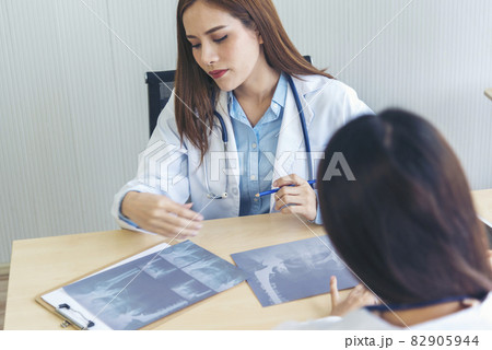 Young asian woman doctor meeting at office table. Two women doctors discussing diagnosis meeting in hospital office medical clinic looking x-ray film consulting patient disease medical lab discussion Young asian woman doctor meeting at office table. Two women doctors discussing diagnosis meeting in hospital office medical clinic looking x-ray film consulting patient disease medical lab discussion 82905944