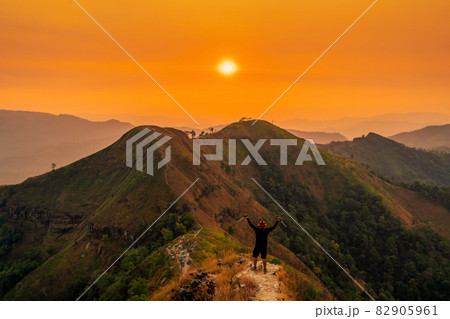 traveler man hiking enjoying in the mountains with backpack at Khao Chang Puak mountain Thailand traveler man hiking enjoying in the mountains with backpack at Khao Chang Puak mountain Thailand 82905961