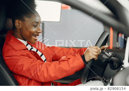 Young african american woman in car salon Young african american woman in car salon 82906154