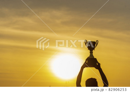 Winner win hands holding golden champion trophy cup prize. Silhouette best award victory hands trophy professional champion challenge team holding gold sport trophy cup. Win-Win sport team concept 82906253
