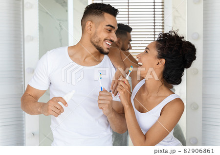 Cheerful Romantic Arab Couple Brushing Teeth And Having Fun In Bathroom Together Cheerful Romantic Arab Couple Brushing Teeth And Having Fun In Bathroom Together 82906861