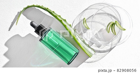 aloe vera face serum in a bottle with dropper and aloe leaf on a laboratory Petri dish. dermatology concept. skin care cosmetic solution for nourishing and moisturizing. top view. aloe vera face serum in a bottle with dropper and aloe leaf on a laboratory Petri dish. dermatology concept. skin care cosmetic solution for nourishing and moisturizing. top view. 82908056
