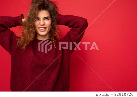 Photo of attractive cute happy emotional young woman poising isolated on background wall with free 82910726