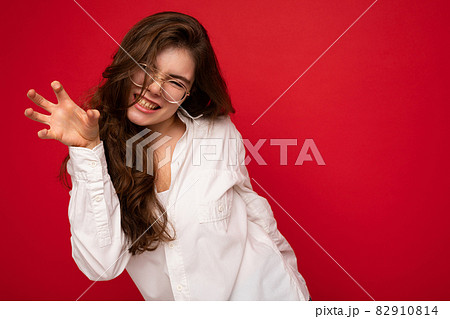 Portrait of young emotional positive sexy beautiful brunette woman with sincere emotions wearing 82910814