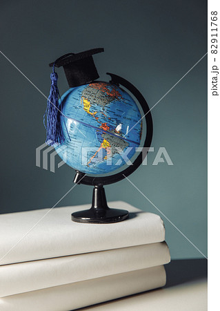 International education concept. Globe with graduation hat on books 82911768