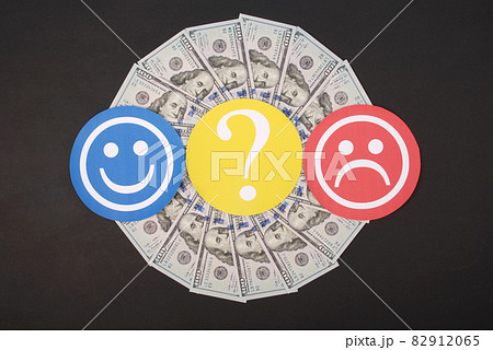 Question mark between smiley and sad smiley on mandala kaleidoscope from money. 82912065