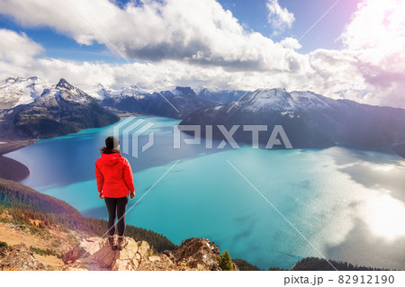 Adventurous Caucasian Woman hiking on top of a Canadian mountain. 82912190