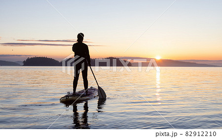 Adventurous Caucasian Adult Woman on a Stand Up Paddle Board 82912210