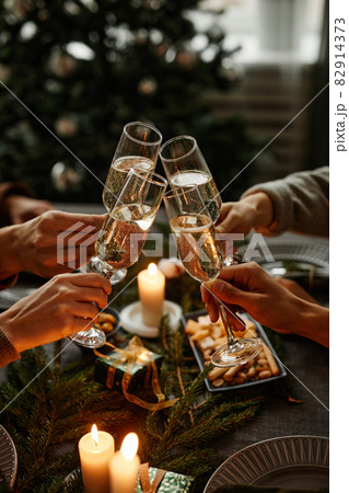 Clinking Glasses at Christmas Dinner 82914373