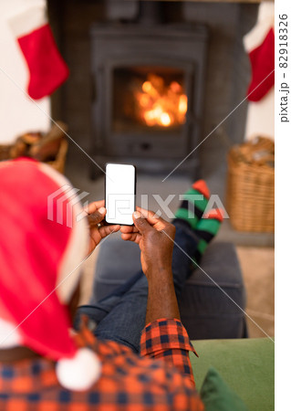 Back view of african american senior man using smartphone with copy space at christmas time 82918326