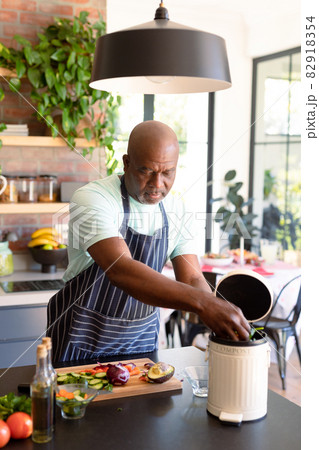Serious african american senior man cooking in kitchen 82918354