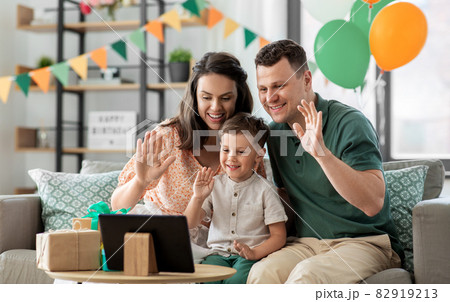 family with tablet pc has video call on birthday family with tablet pc has video call on birthday 82919213