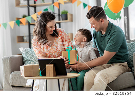 happy family giving present to little son at home 82919354