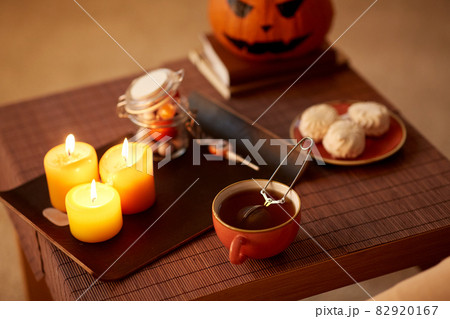 mesh tea infuser ball in ceramic mug on halloween 82920167