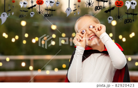 girl in halloween costume of dracula with eyeballs 82920423