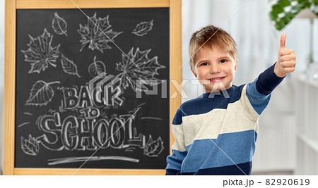 little student boy showing thumbs up 82920619