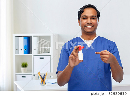 smiling indian male doctor or nurse with medicine smiling indian male doctor or nurse with medicine 82920659