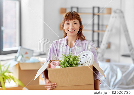 happy woman unpacking boxes and moving to new home happy woman unpacking boxes and moving to new home 82920759