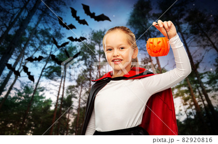 girl in halloween costume of dracula with pumpkin girl in halloween costume of dracula with pumpkin 82920816