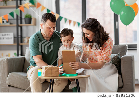 happy family opening birthday presents at home happy family opening birthday presents at home 82921206