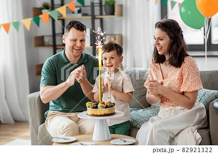 happy family with birthday cake at home 82921322