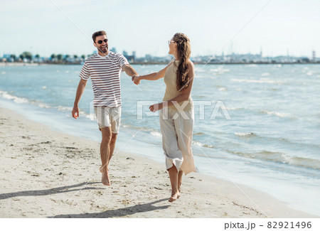 happy couple running along summer beach happy couple running along summer beach 82921496