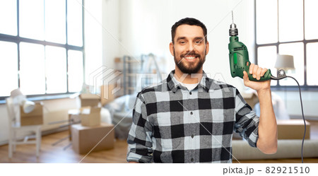 happy man, worker or builder with drill at home 82921510