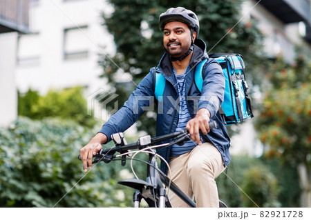 indian delivery man with bag riding bicycle indian delivery man with bag riding bicycle 82921728