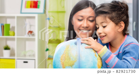 mother and daughter with globe at home mother and daughter with globe at home 82921730