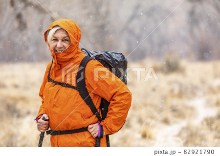 USA, Utah, Escalante, Woman hiking during snow flurry in Grand Staircase-Escalante National Monument USA, Utah, Escalante, Woman hiking during snow flurry in Grand Staircase-Escalante National Monument 82921790