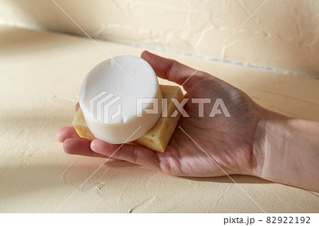 hand holding bar of craft soap on beige background 82922192