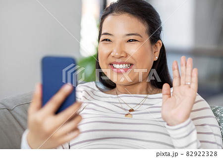 asian woman with smartphone having video call 82922328