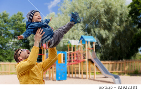 father with son playing and having fun outdoors 82922381