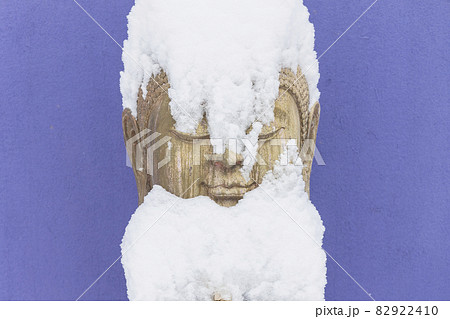 Snow covering stone Buddha statue 82922410