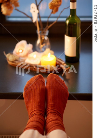 feet in socks on window sill at home in autumn feet in socks on window sill at home in autumn 82922711