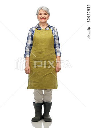 portrait of smiling senior woman in garden apron portrait of smiling senior woman in garden apron 82922956