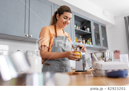 happy young woman cooking food on kitchen at home happy young woman cooking food on kitchen at home 82923201