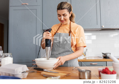 woman cooking food and baking on kitchen at home 82923206