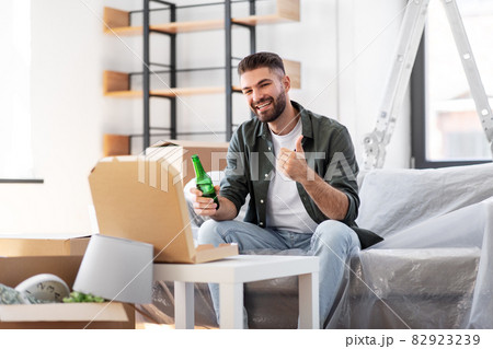 man with box of pizza and beer bottle at new home man with box of pizza and beer bottle at new home 82923239