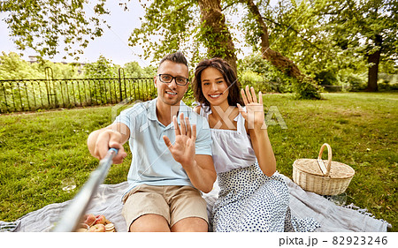 happy couple taking selfie at picnic in park happy couple taking selfie at picnic in park 82923246